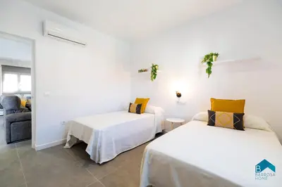 two beds in a room with white walls at Sauz A in Novo Sancti Petri