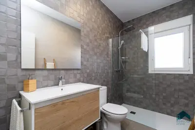 a bathroom with a sink and a toilet and a mirror at Sauz A in Novo Sancti Petri