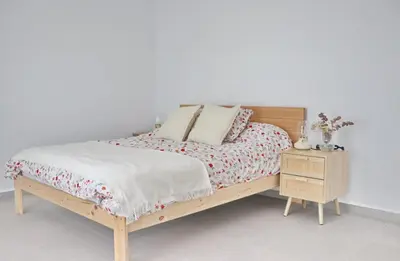 a bedroom with a wooden bed and a night stand at Villa Buganvilla in Conil de la Frontera