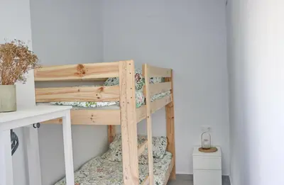 a wooden bunk bed in a room at Villa Buganvilla in Conil de la Frontera