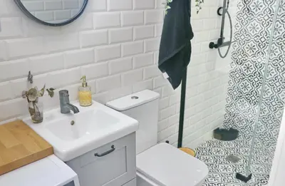 a white bathroom with a sink and a shower at Villa Buganvilla in Conil de la Frontera
