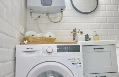 a laundry room with a washing machine and a sink at Villa Buganvilla in Conil de la Frontera