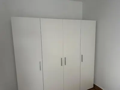 a row of white cabinets in a room at Apartamentos Bajo Guía in Sanlúcar de Barrameda