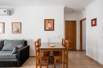 a living room with a table and a couch at coto 7 8 in Chiclana de la Frontera