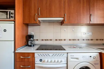a kitchen with a stove and a dishwasher at coto 7 8 in Chiclana de la Frontera