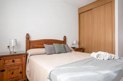 a bedroom with a bed with two towels on it at coto 7 8 in Chiclana de la Frontera