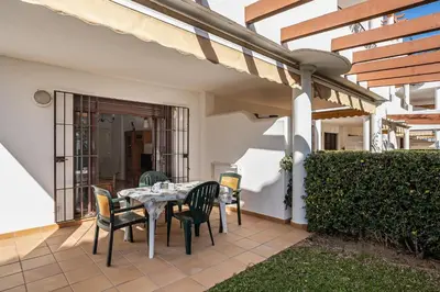 a patio with a table and chairs on a house at coto 7 8 in Chiclana de la Frontera