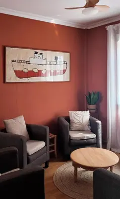 a living room with two chairs and a table at Dolce Vita Chiclana in Chiclana de la Frontera