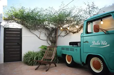 a green truck with a chair next to a building at Dolce Vita Chiclana in Chiclana de la Frontera