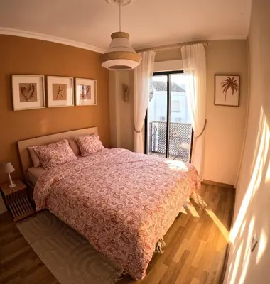 a bedroom with a bed and a balcony at Dolce Vita Chiclana in Chiclana de la Frontera