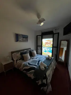 a bedroom with a bed with two towels on it at Apartamento Riviera in Novo Sancti Petri
