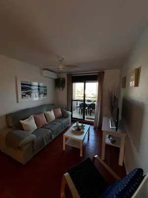 a living room with a couch and a table at Apartamento Riviera in Novo Sancti Petri
