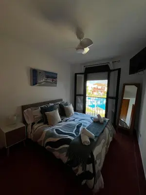 a bedroom with a bed with towels on it at Apartamento Riviera in Novo Sancti Petri