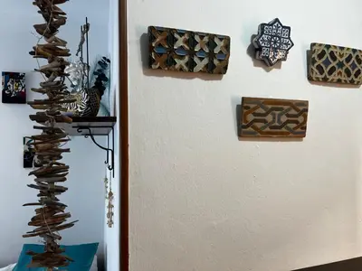a wall with many different types of art on it at El rincón de Malandar in Sanlúcar de Barrameda