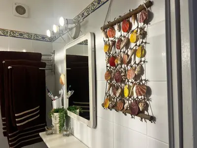 a bathroom with a mirror and a sink at El rincón de Malandar in Sanlúcar de Barrameda