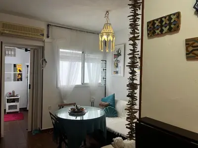 a living room with a table and a couch at El rincón de Malandar in Sanlúcar de Barrameda