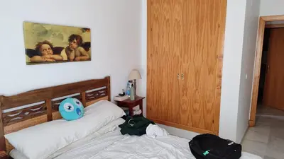 a bedroom with two beds and a painting on the wall at El Falla in Cádiz