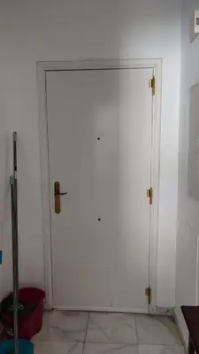 a large white door in a white room at El Falla in Cádiz
