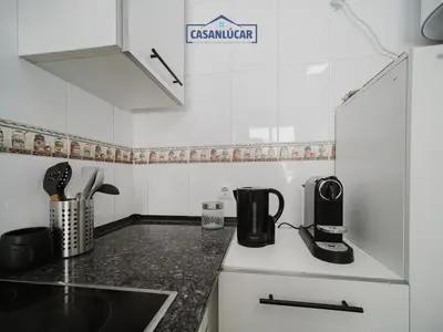 a kitchen with a counter top with a coffee maker at Piso Atlantis in Sanlúcar de Barrameda