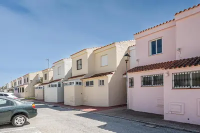 a row of houses with garages in a parking lot at Balconera 79 in Chiclana de la Frontera