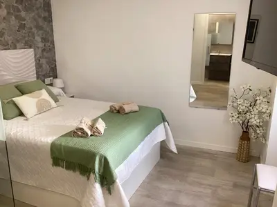 a bedroom with a bed with two towels on it at Apartamento La Guitarra in Jerez de la Frontera