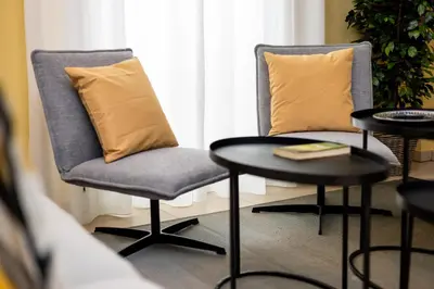 two chairs and a table with a pillow on them at Brisa Jerez Suites in Jerez de la Frontera