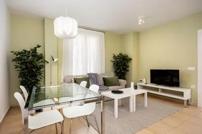 a living room with a glass table and a couch at Brisa Jerez Suites in Jerez de la Frontera