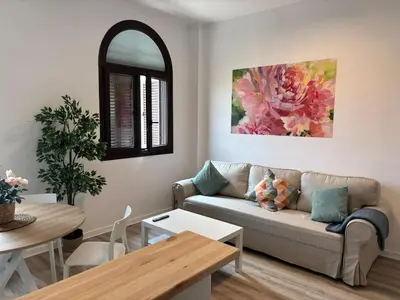 a living room with a couch and a table at Acogedor apartamento, céntrico, recién restaurado in Jerez de la Frontera
