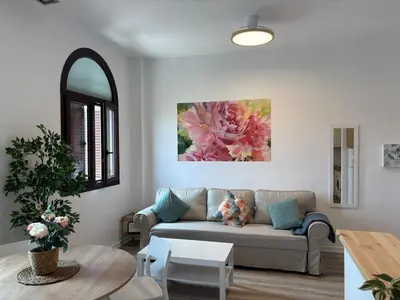 a living room with a couch and a table at Acogedor apartamento, céntrico, recién restaurado in Jerez de la Frontera