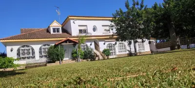 a large white house with a yard in front of it at Hacienda Laguna Seca - Apart. Lavanda in Chiclana de la Frontera