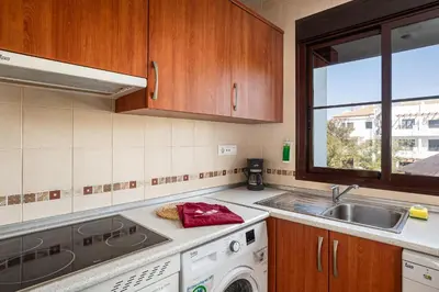 a kitchen with a sink and a washing machine at coto 2 18 in Chiclana de la Frontera