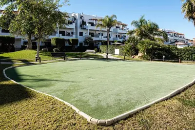 a tennis court in front of a building at Coto 10 11 in Chiclana de la Frontera