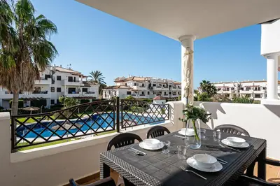 a table on a balcony with a view of the water at coto 9 16 in Chiclana de la Frontera