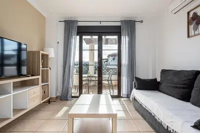 a living room with a couch and a tv at coto 8 22 in Chiclana de la Frontera
