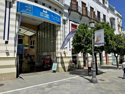 a building with a sign on the side of a street at Larga Suite 46 - Ole Solutions in Jerez de la Frontera