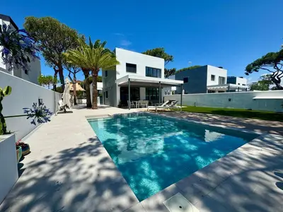 a swimming pool in the backyard of a house at Villa Agua Salá in Poblado de Sancti Petri