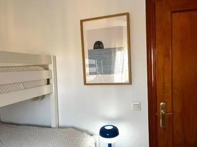 a bedroom with a mirror and a bunk bed at Relax rooftop in the palm trees in Novo Sancti Petri