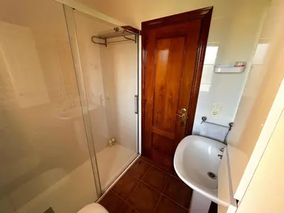 a bathroom with a shower and a toilet and a sink at Relax rooftop in the palm trees in Novo Sancti Petri