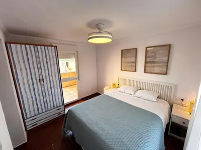 a bedroom with a bed and a large window at Relax rooftop in the palm trees in Novo Sancti Petri