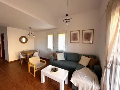 a living room with a couch and a table at Relax rooftop in the palm trees in Novo Sancti Petri