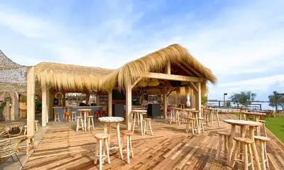 a restaurant with tables and stools on a wooden deck at Ribera del río - Centro in El Puerto de Santa María