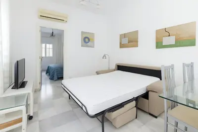 a hospital room with a bed and a tv at Ribera del río - Centro in El Puerto de Santa María