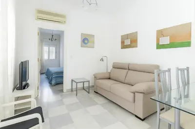 a living room with a couch and a table at Ribera del río - Centro in El Puerto de Santa María