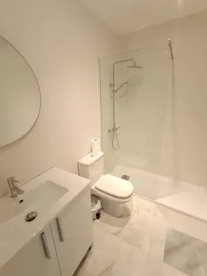 a white bathroom with a toilet and a shower at Ribera del río - Centro in El Puerto de Santa María