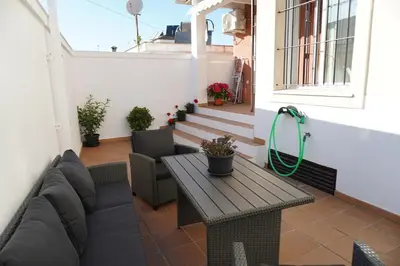 a patio with a table and chairs on a balcony at Brisa Marina in Sanlúcar de Barrameda