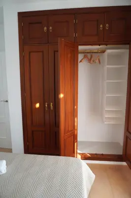 a bedroom with a cupboard and a closet at Brisa Marina in Sanlúcar de Barrameda