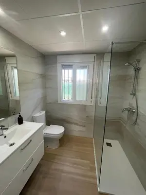 a bathroom with a toilet and a sink and a shower at Sunset Palm in El Puerto de Santa María