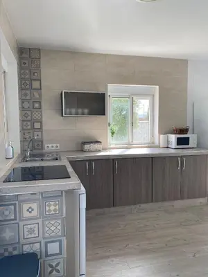 a kitchen with a sink and a microwave at Villa Hebane in El Puerto de Santa María