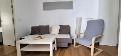 a living room with a couch and a table and a chair at Cobos by Gades Gestión in Cádiz