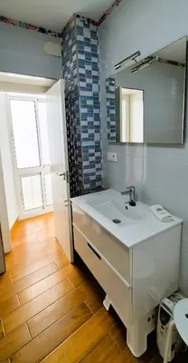 a bathroom with a white sink and a mirror at Cobos by Gades Gestión in Cádiz